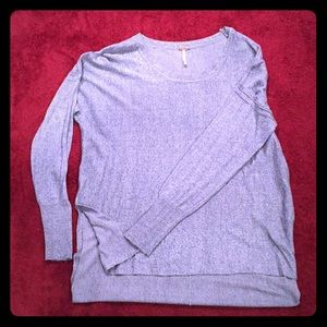 a long sleeved, light weight blue shirt